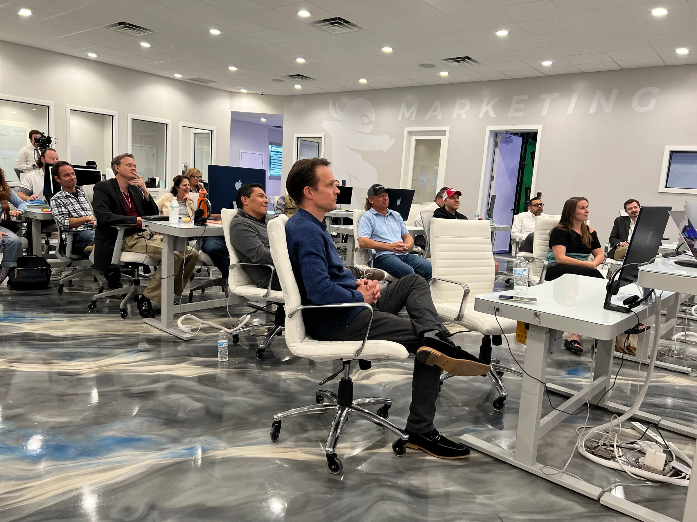 The AGM workshop room in Largo, Florida: attendees and staff working at long desks