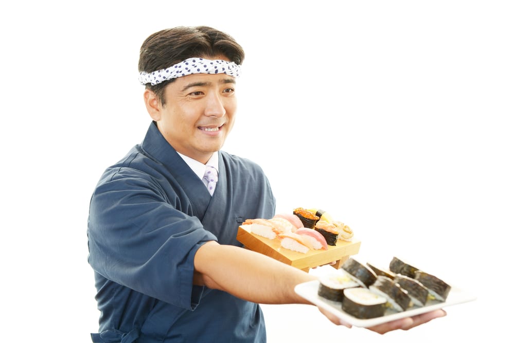 japanese chef serving sushi