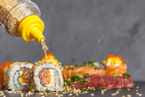 Sesame seeds on delicious sushi made by a chef