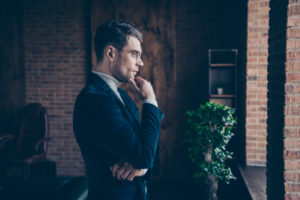 Profile side view portrait of nice handsome stylish guy eyeglasses eyewear shark specialist leader consultant attorney lawyer realtor looking at window at industrial loft interior workplace workspace.