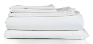 Stack of clean bedding sheets isolated on white