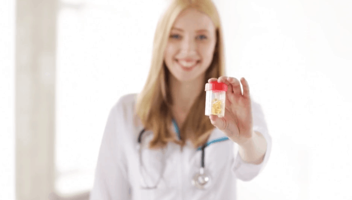 girl holding a small bottle of capsules